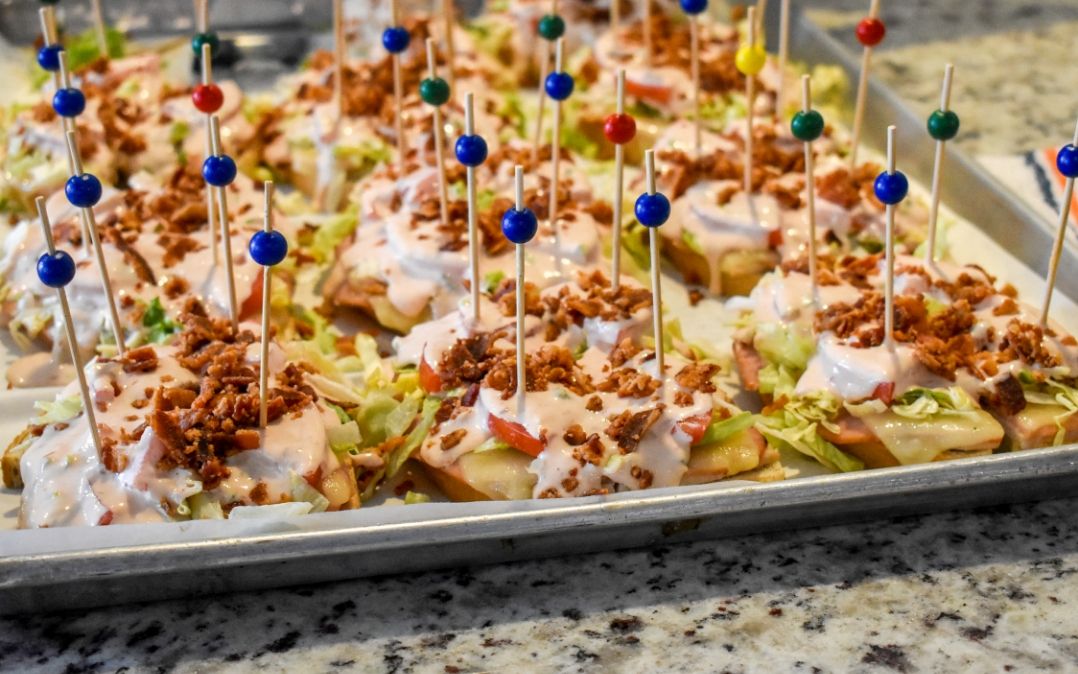 Beautifully plated bite-sized appetizers at the Willow Brook Village courtyard in Delaware, Ohio, illustrating the catered dining events that enrich senior living.